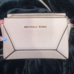 Michael kors purse with rose gold chain and logo.